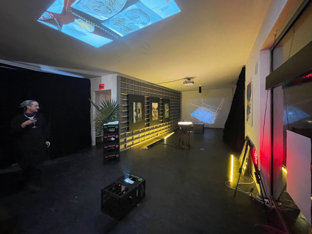 Exhibition main room with multimedia installations and projections on wall and ceilling